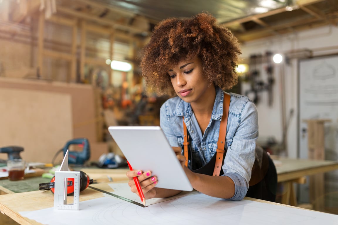 Young woman using a tablet in her workshop